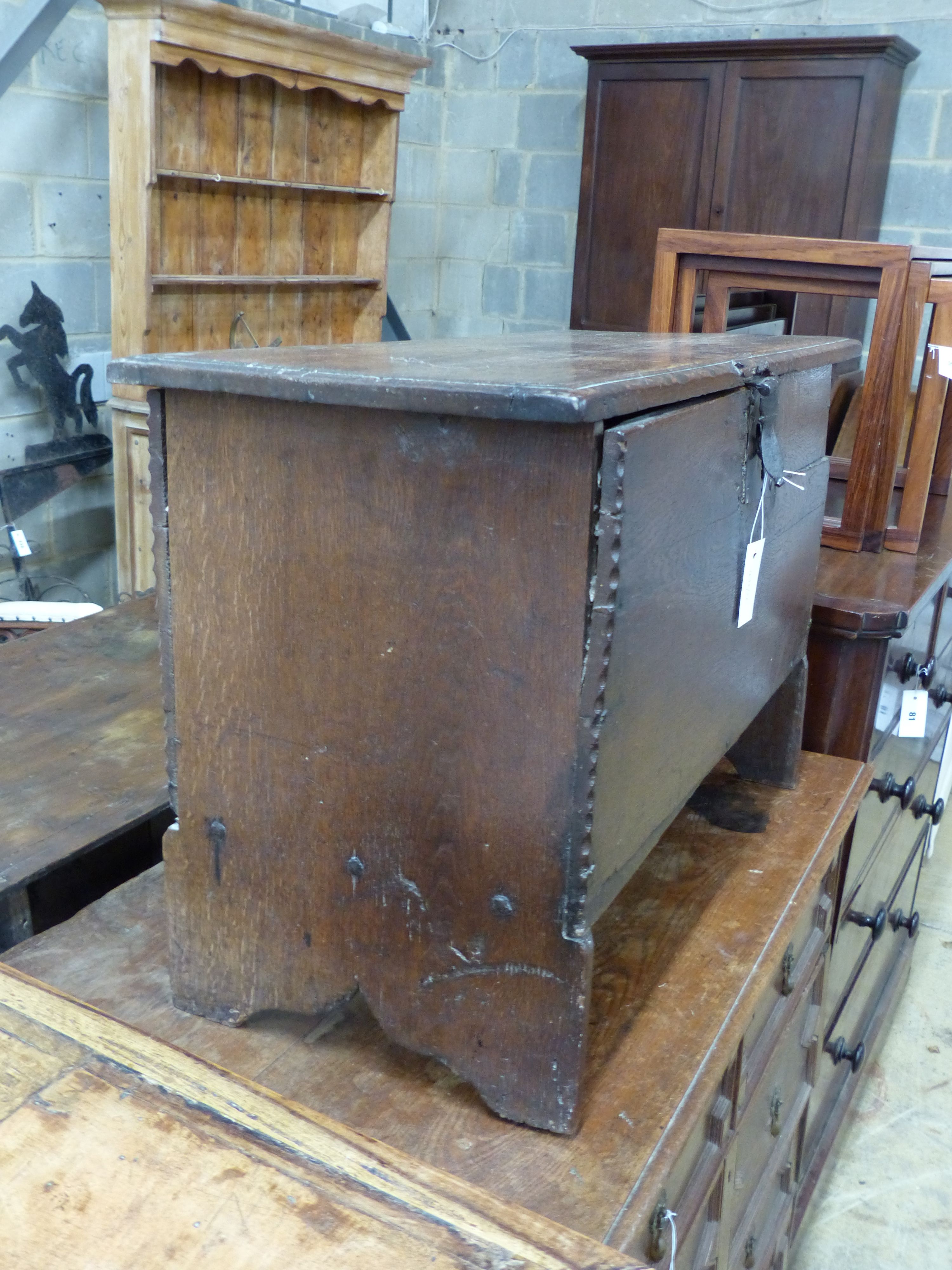 A 17th century oak six plank coffer with candle box (top a.f.), width 73cm